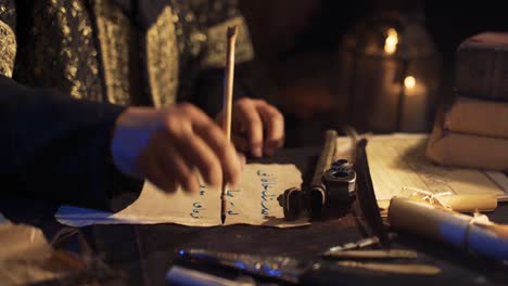 Taking-out-a-pen-from-the-inkwell.-Writing-letters-in-ancient-times.